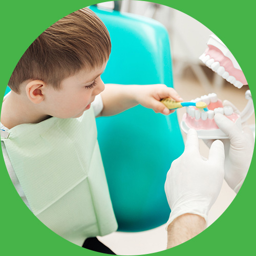 Boy learning how to brush teeth