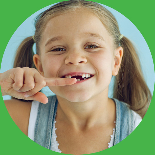 Smiling girl with missing front teeth